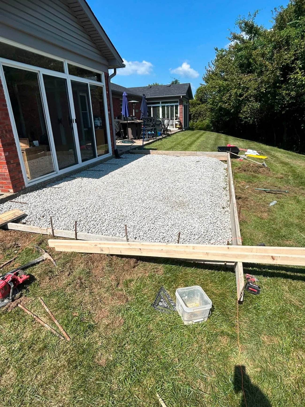 Gravel base and wooden forms set for a backyard patio pour